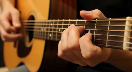 Fototapeta premium Close up of hand playing acoustic guitar creating music melodies