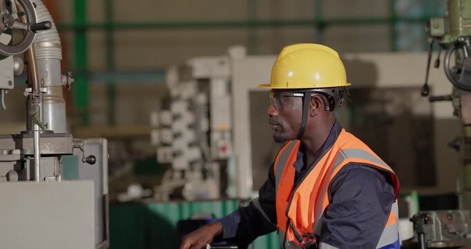 A technician performs precision grinding and close inspection on a metal component in a manufacturing facility, showing finishing work, process control, and industrial supervision.
