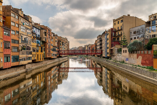 Colorful Houses and Iconic Red Eiffel Bridge over the Onyar River in Girona, Spain