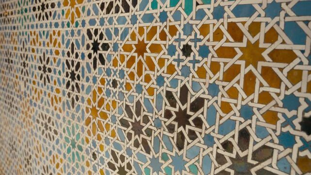 Close-up of colorful geometric tile patterns inside Real Alc&aacute;zar in Seville, Spain, showcasing intricate Moorish design, symmetry, and historic craftsmanship.