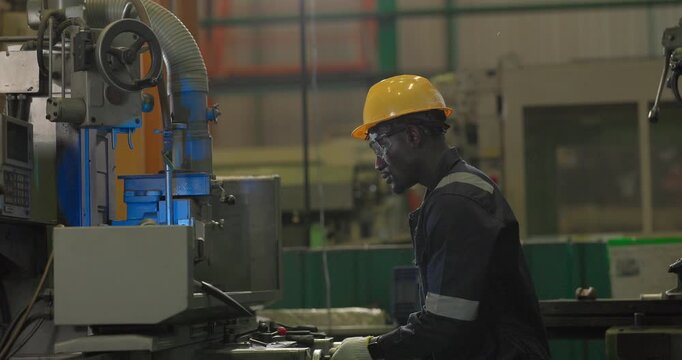 A technician performs precision grinding and close inspection on a metal component in a manufacturing facility, showing finishing work, process control, and industrial supervision.
