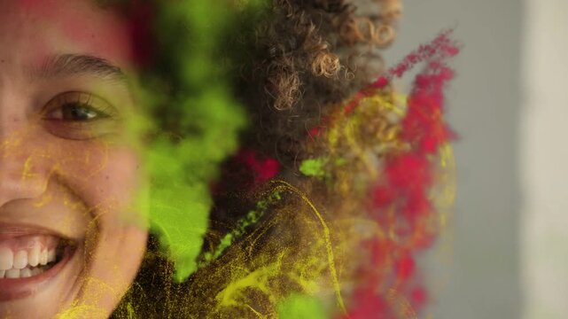 Female model, color swaths sweeping from right over face, forming yellow particles for beauty ad
