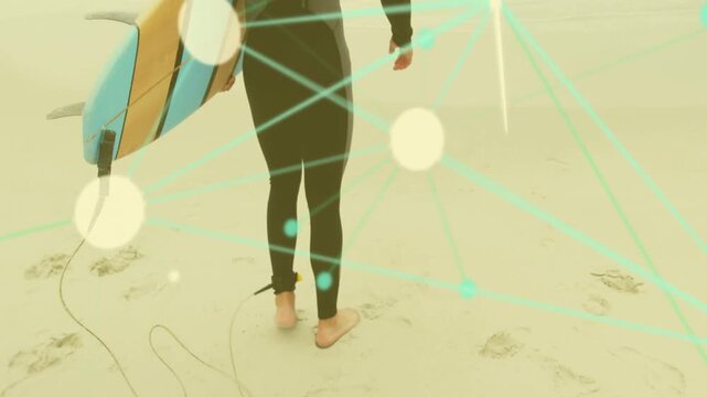 Surfer walking on wet sand, heading to waves, holding board with ankle leash, bokeh lines moving