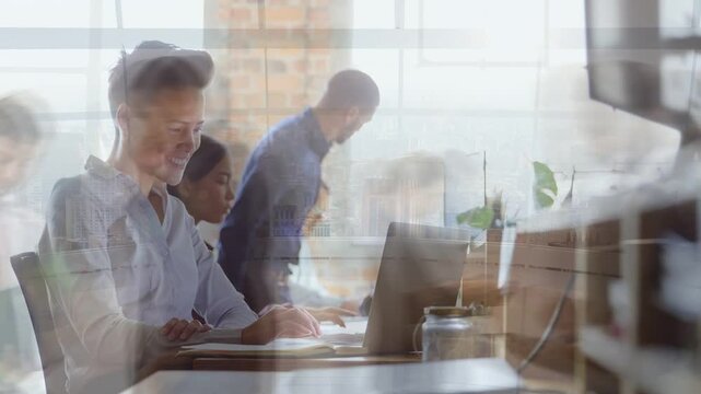 Teen female typing laptop, glancing notes while working project, causing ghost overlays in office