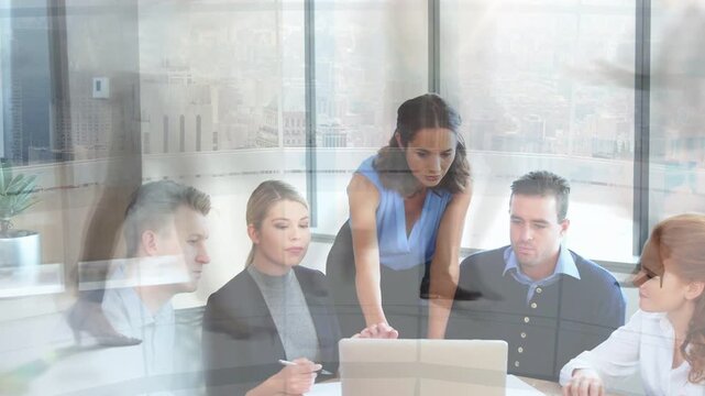 Female presenter tapping laptop, overlay clearing, business team leaning in to review project