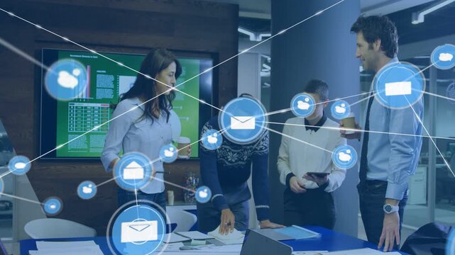 Team of four collaborating while phone alert sparking mail icon forming business network over table