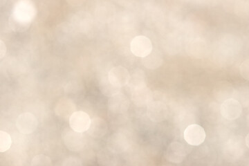 Abstract light beige bokeh background with blurred lights © Peresada