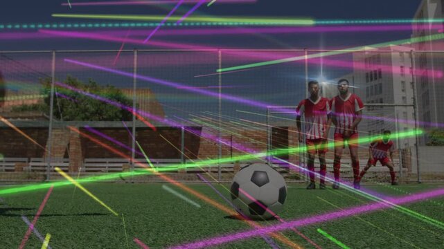 Kicker running and kicking ball seeking goal in sports freekick, wall reacting under neon veil