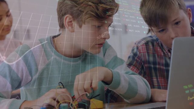 Vertical video: Leaning boy in striped tee testing kit in class, viewing laptop, overlay appearing