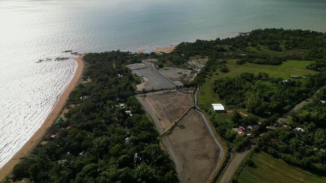 Sweeping aerial shot capturing coastal wetlands and sandy beaches on Guimaras Island. Perfect for environmental studies and travel promotions.