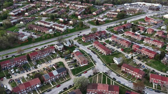 Aerial top-down view of Baltimore residential neighborhood with brick row houses, intersecting streets and light traffic, showing urban suburban layout and housing density in Maryland, USA.
