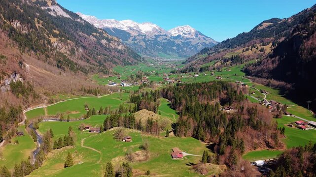 Aerial: Kandertal valley landscape in Bernese Oberland during the day in Kandergrund, canton of Bern, Switzerland, establishing drone shot