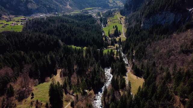 Aerial: Kander river and Kandertal valley near Blausee in Bernese Oberland during the day in Kandergrund, canton of Bern, Switzerland, push in drone shot