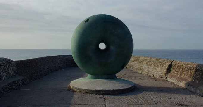 shot of the Afloat Sculpture On Brighton beach next to Brighton pier