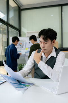 Stressed asian businessman working in the office. Businessman thinking too much work concept in the office.
