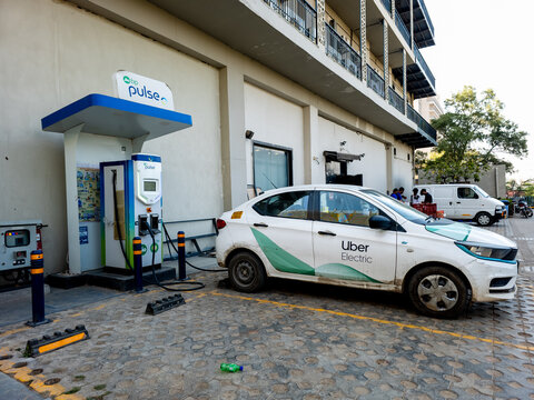 Delhi, India - 28th Mar 2026: An electric Uber cab charges at a public Jio BP Pulse EV station in Delhi, highlighting sustainable transport, clean energy adoption, and urban mobility infrastructure in