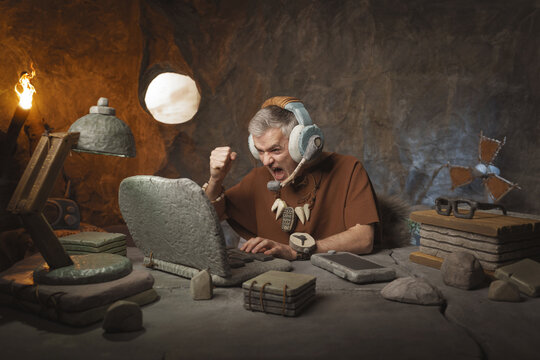 Angry prehistoric call center agent with headset working in the office