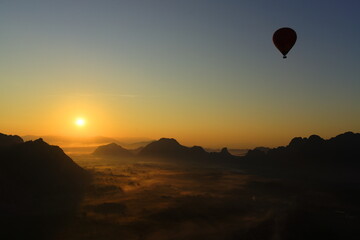 Fototapeta premium flying hot air balloon at sunrise