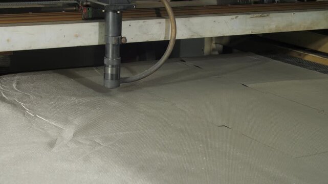 Cutter performs precise cuts on radio-blocking material. Machine shapes to exact specifications for effective electromagnetic shielding