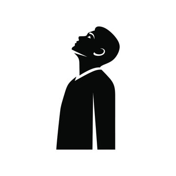 Silhouette of a young man looking up.