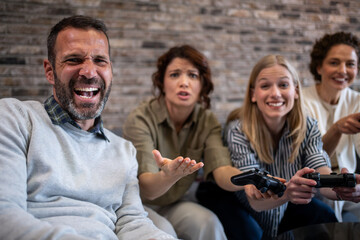 Fototapeta premium Friends playing video games having fun and competition
