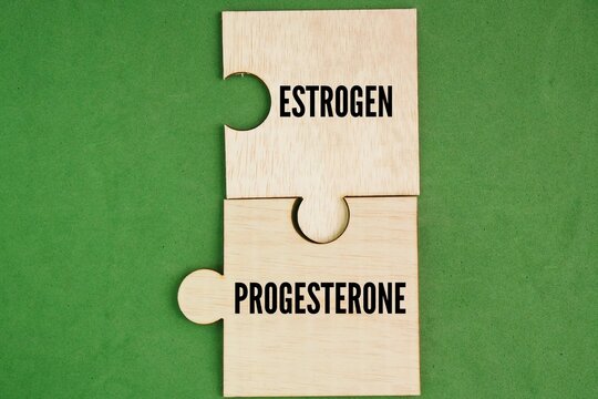 Wooden puzzle with word estrogen and progesterone. concept of female hormones and menopause. Estrogen and progesterone are two key hormones made mostly by the ovaries