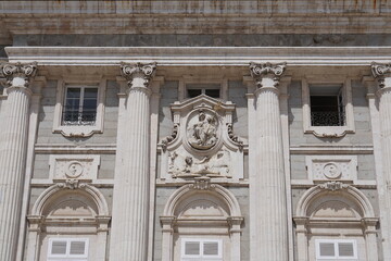 Fototapeta premium Ornate Stone Relief Sculpture and Corinthian Columns on Royal Palace Facade Madrid