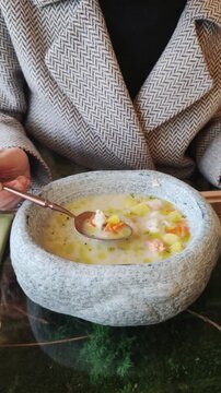 Close up of chunky fish stew in ceramic bowl representing culinary heritage. Nourishing meal evoking comfort, tradition, and wholesome dining experience.