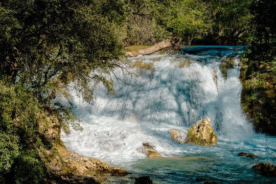 Powerful waterfall on the Caramy River near Cotignac, Var, Provence-Alpes-Cote d&rsquo;Azur, France. Turquoise water flowing over rocks in a natural forest landscape