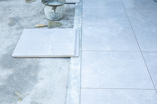 Outdoor tile installation on concrete patio