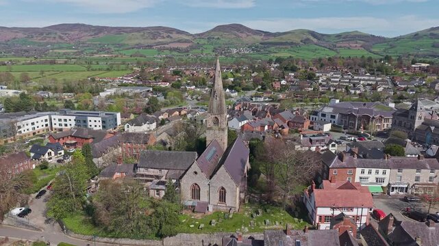Aerial, stone architecture and prominent spire of the historic church in the heart of Ruthin town in North Wales