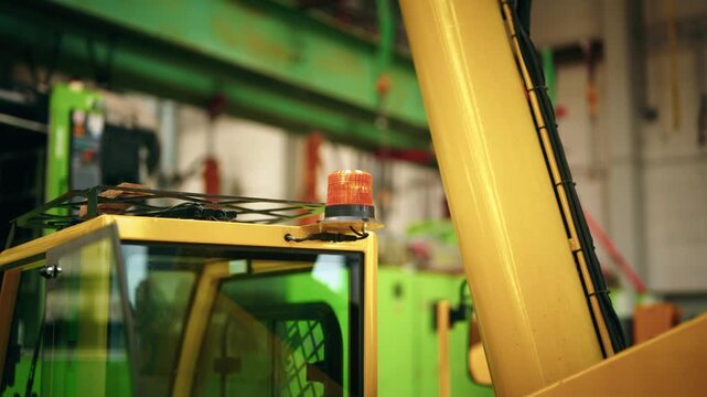 Close-up of a blinking warning beacon mounted on a crane indicating active machinery operation.