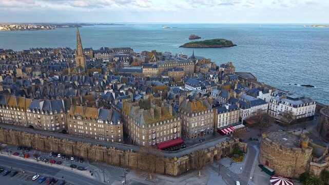 Panoramic drone fly near Intra Muros district with Porte St Vincent and Grand Bé, Petit Be forts in background, Saint-Malo, Ille-et-Vilaine, France