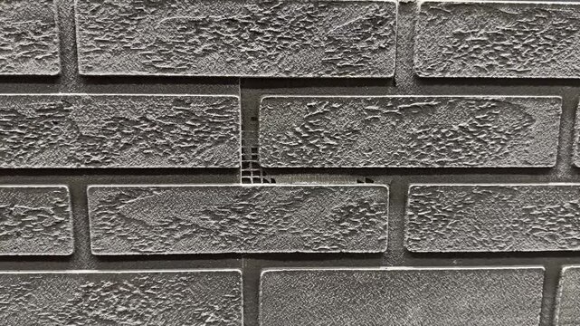 Dark gray brick wall surface pattern detail