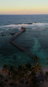vertical of General Luna Siargao Island Cloud 9 boardwalk famous surfing spot in Philippines , aerial drone