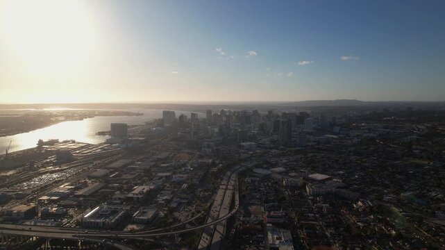 Drone flying above the skyline at 6PM heading north toward downtown San Diego capturing a wide elevated view.