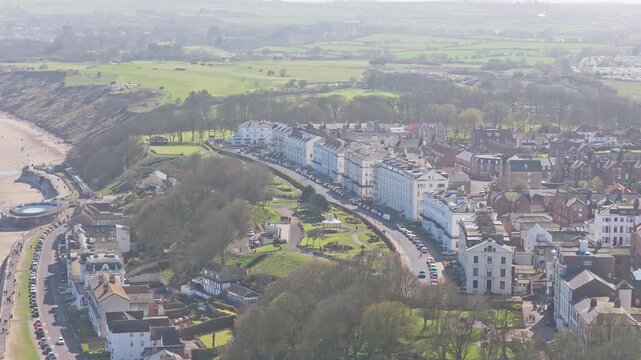 The Crescent and Royal Crescent in Filey North Yorkshire England overlooking Filey Bay with Ravine Road below, Victorian seafront terraces on cliff edge above promenade and North Sea establishing shot