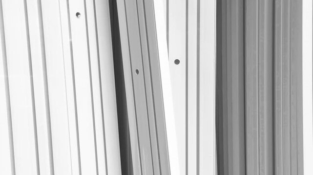 Parallel metal panels in grayscale with shadows