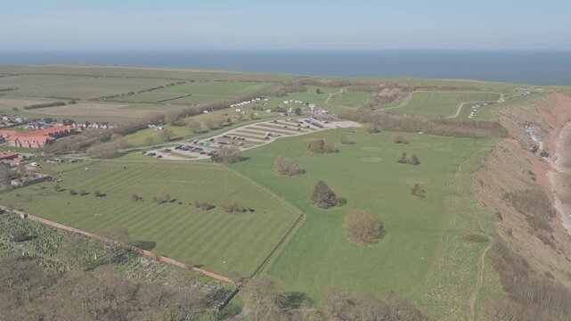 Cliff top farmland near Ravine Road Filey North Yorkshire England with arable fields and improved pasture typical of cereal and grass rotation on chalk and glacial soils above North Sea coast, aerial