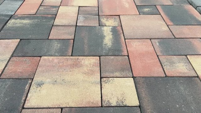 Textured paving stones arranged in a geometric pattern on a surface