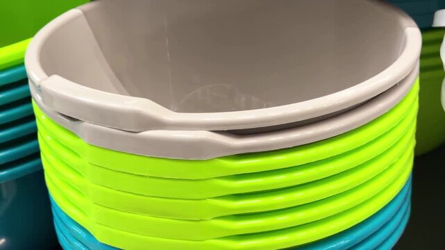 Stack of colorful plastic buckets with handles