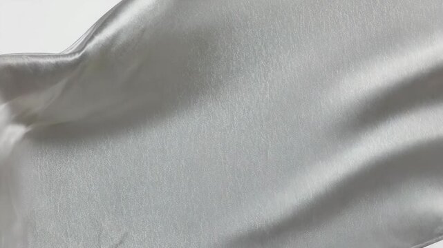 A close-up view of smooth fabric texture in a natural environment with soft folds and gentle curves on the surface.
