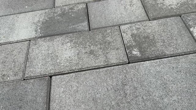 Gray concrete paving stones arranged in rows