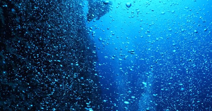 air bubbles slow  underwater coming up scenery dark blue and sun shine ocean scenery from scuba  divers backgrounds