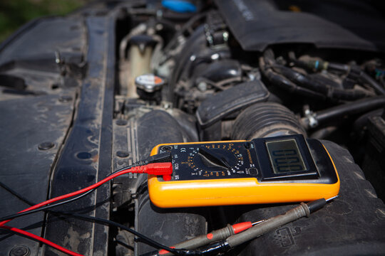 Close-up of a multimeter on the background of the car