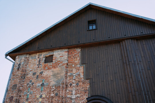 The building is half brick, half wooden against a blue sky background. The Church of St. Boris and Gleb (Kolozhskaya). Architectural monument