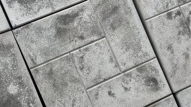 Gray paving stones laid in a pattern on the ground