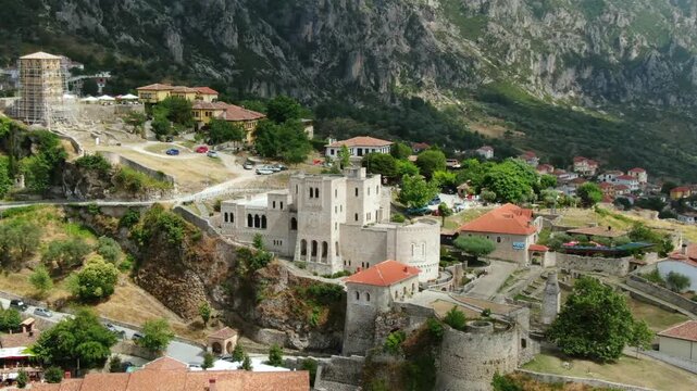 Panoramic drone footage of the medieval Kruje Castle in Albania. The historical fortress and Skanderbeg Museum sit on a rocky cliffside