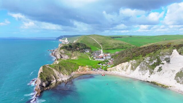 Ascending aerial shot of Lulworth cove and Dorset jurassic coastline on a sunny day