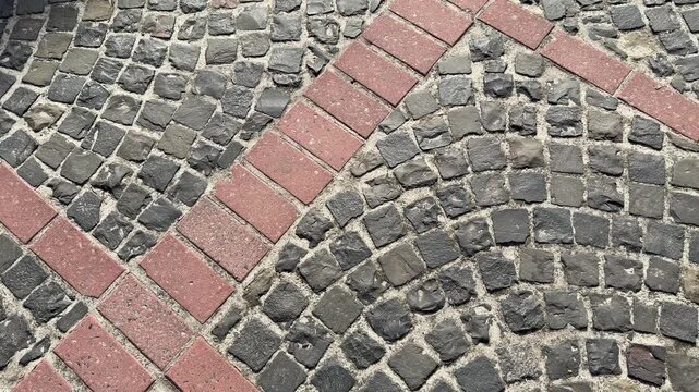 Cobblestone path with red brick accents